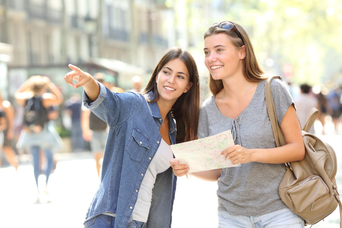 Girl helping to a tourist who asks direction